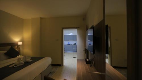 a hotel room with a bed and a bathroom at Triple E Hotel and Spa in Addis Ababa