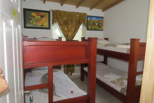 a bedroom with three bunk beds in a room at Los Flamingos Vip in Santa Rosa