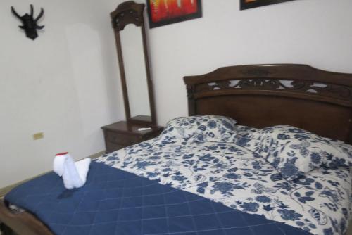 a bed with a blue and white comforter and pillows at Los Flamingos Vip in Santa Rosa