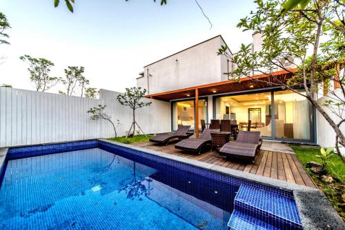 an external view of a house with a swimming pool at Jeju Breeze in Seogwipo