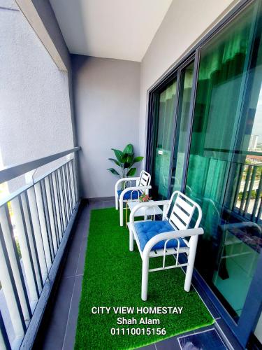 two chairs and a table on a balcony at Cityview Homestay Seksyen 13 Shah Alam, Aeon Mall, Stadium, I-City in Shah Alam