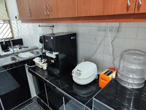 a kitchen with a coffee maker on a counter at Aydan Homestay, UTM, Taman Sri Pulai, Skudai in Johor Bahru