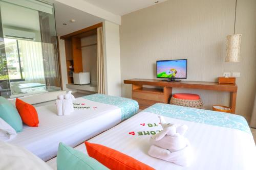 two beds with hello kitty towels on them in a room at Bandara Beach Resort, Phuket in Panwa Beach