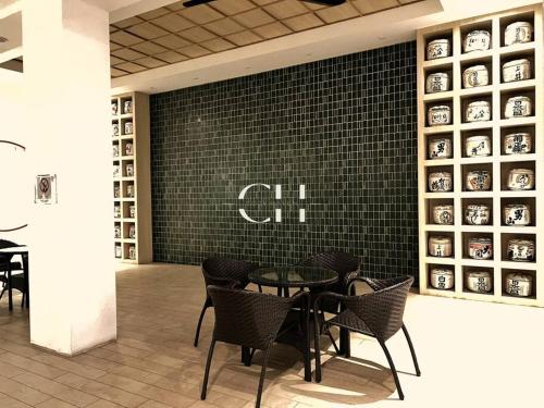 a restaurant with a table and chairs in a room at Zen 66 near to Boulevard & Aeon Kuching in Kuching