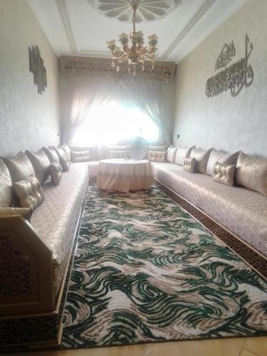 a living room with a couch and a carpet at Meknès kamilia in Meknès