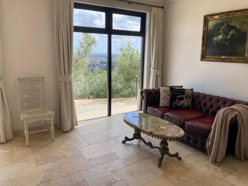 a living room with a couch and a table and a window at Adelaide and Adelaide Hills self contained private guest suite in Montacute