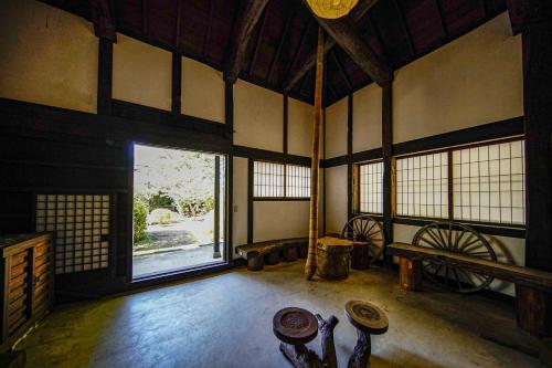 a room with a large window and a room with tables at 甘糟屋敷 Amakasu Yashiki KAMAKURA in Kamakura