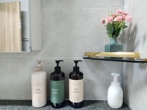 a group of three bottles sitting on a shelf at Sunshine Aewol Entire House in Jeju