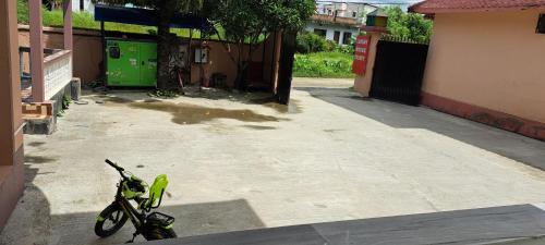 a green bike parked on the side of a street at London House Resort in Birātnagar