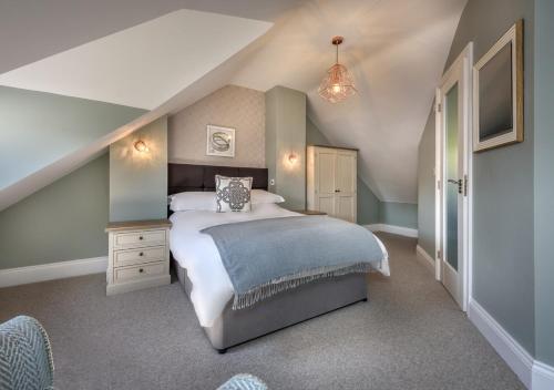 a bedroom with a large bed in a attic at Hafan Dawel in Abersoch