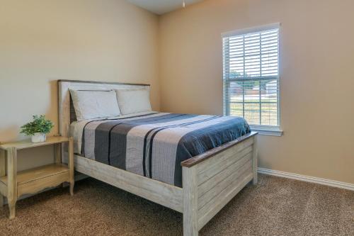 a bedroom with a wooden bed with a window at McKinney Home with Backyard, 10 Mi to Dtwn! in McKinney