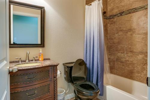 a bathroom with a sink and a toilet and a shower at McKinney Home with Backyard, 10 Mi to Dtwn! in McKinney