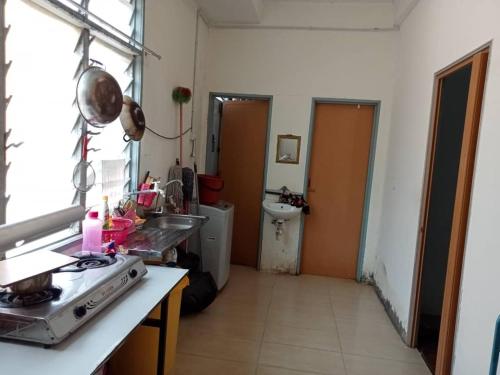 a kitchen with a sink and a toilet in a room at Dena Moon inn in Kota Bharu