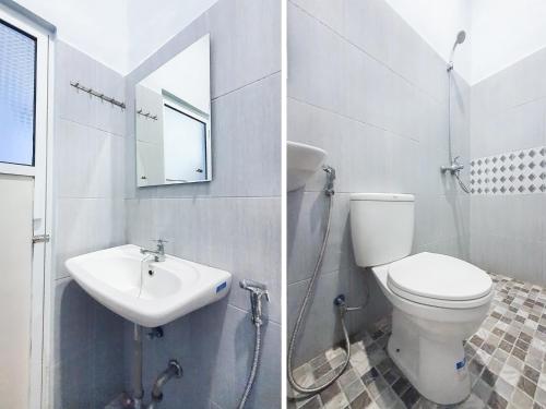 a bathroom with a toilet and a sink at OYO 3160 Guesthouse Pagi Sore Syariah in Padang