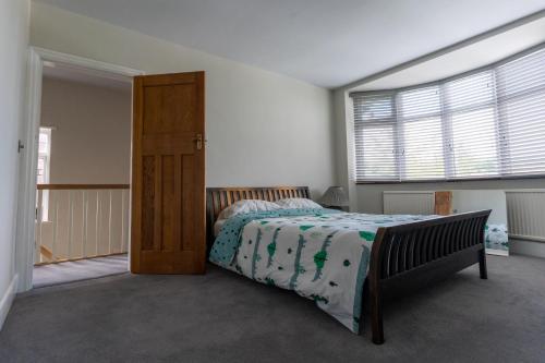 a bedroom with a bed and a large window at Luxurious Private Accommodation Manchester Airport Stay Park And Fly Lyme Park in Hazel Grove