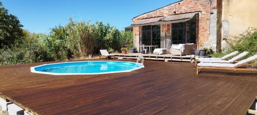 a deck with a swimming pool on top of a house at Anexo Casa São Miguel the beauty of imperfection in Santarém