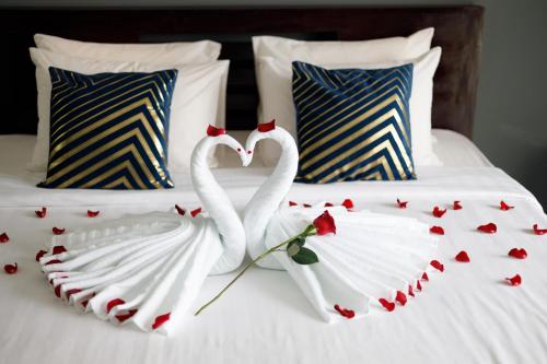 two white swans making a heart on a bed at Ratana Angkor Hotel in Siem Reap