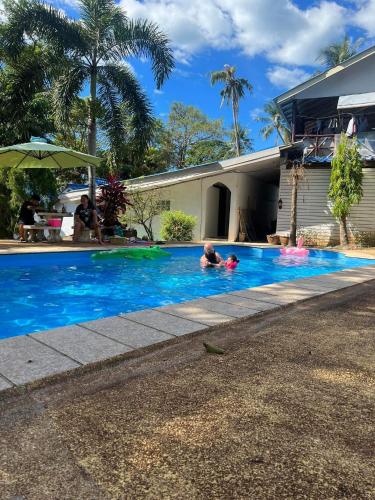 a group of people swimming in a swimming pool at cher lonely beach resort Koh chang in Ko Chang
