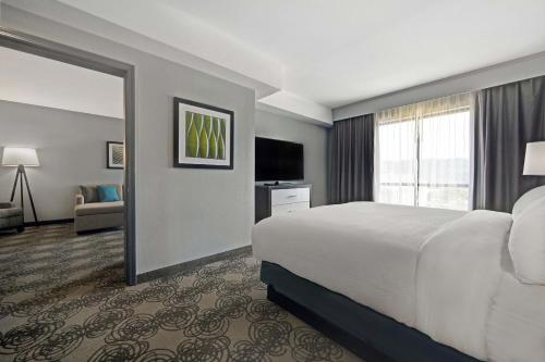 a hotel room with a bed and a large window at Four Points by Sheraton Birmingham Homewood in Homewood