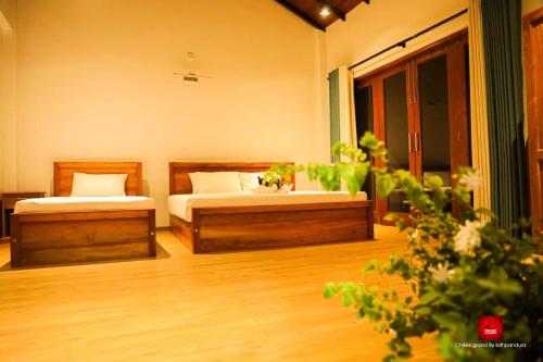 a bedroom with two beds in a room at Chillies Grand by Lathpandura, Polonnaruwa in Polonnaruwa