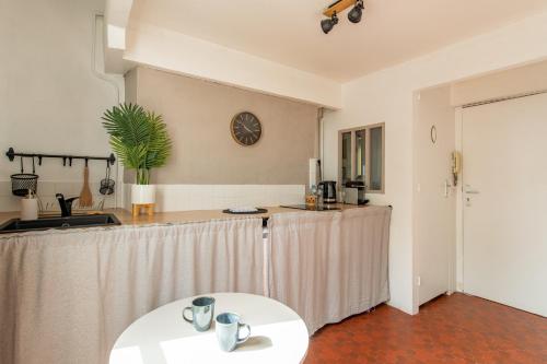 une cuisine avec une table et un comptoir dans l'établissement Charming Apartment in the Heart of Versailles, à Versailles