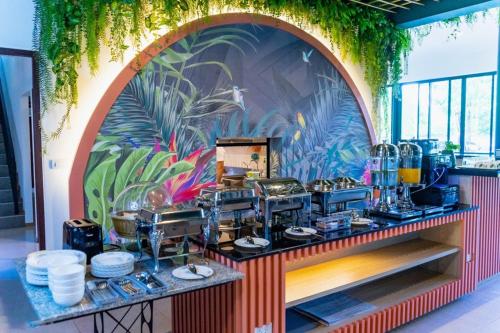 a buffet with a colorful mural on the wall at JINGLE JUNGLE RESORT KHAOYAI in Mu Si