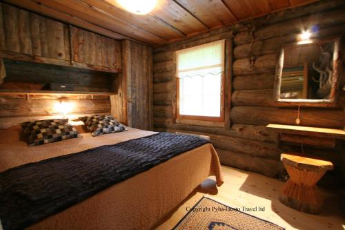 Кровать или кровати в номере Log House Siesta