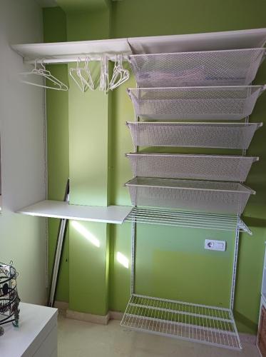 a shelf in a room with green walls at Casa María in Gabia la Chica
