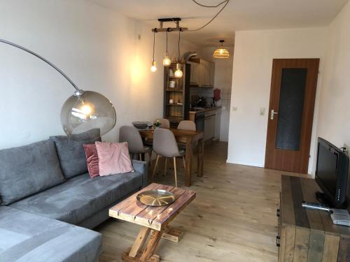 a living room with a couch and a table at Zu Hause am See - Pool, Sauna, Fitnessraum in Schluchsee