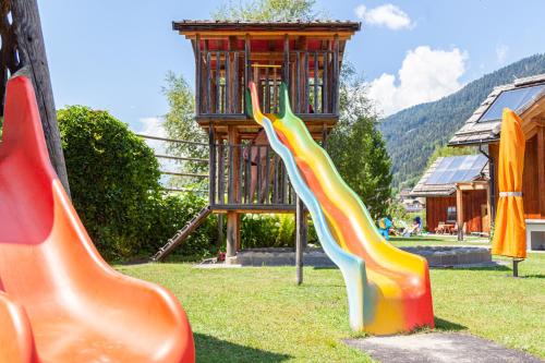 two slides in a playground with a tower at Seehaus Winkler in Weissensee