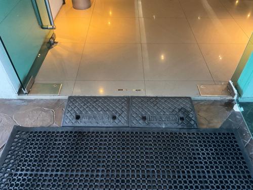 an overhead view of a metal grate in a bathroom at Pandora's Nest in Manila