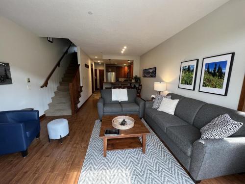 a living room with a couch and a table at Trappers Landing #34 in Sun Peaks