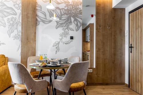 a dining room with a table and chairs at Mokka House Panzió in Miskolc