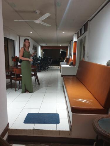 a woman standing in a room with a couch at Villa Authentique in La Digue