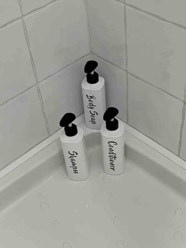 three bottles sitting on a counter in a bathroom at Kylemore Lakeview Retreat in Blessington