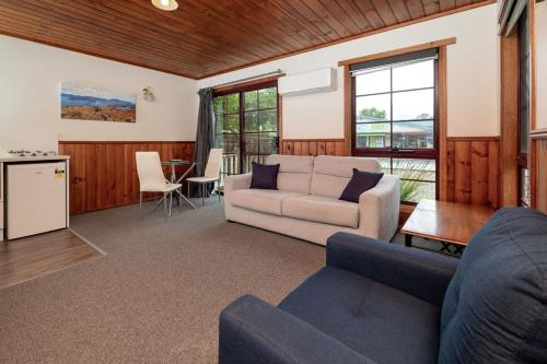 a living room with a couch and a table at Kitty's Cottages - Managed by BIG4 Strahan Holiday Retreat in Strahan