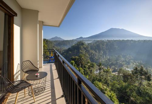 a balcony with a table and chairs and a view at Tapa Agung View Besakih in Menanga