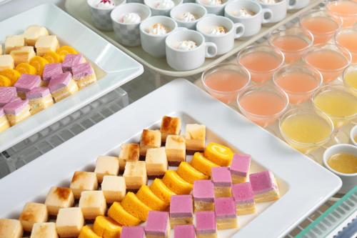 a table with three trays of different types of desserts at Spa and Resort Hotel Solage Oita Hiji Beppuwan in Beppu