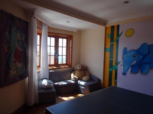 a childrens room with a couch and a stuffed elephant at The Oberoi Cecil in Shimla