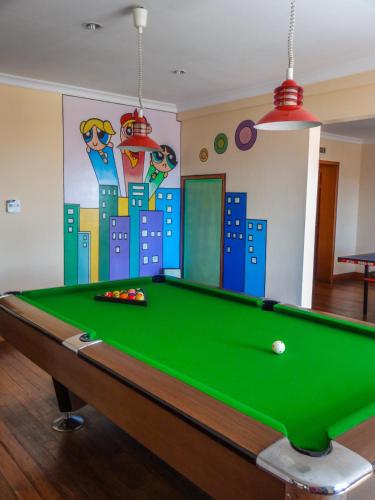 a pool table in a room with a mural at The Oberoi Cecil in Shimla