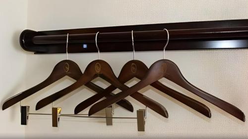 a group of wooden utensils hanging from a rack at Toyoko Inn Chubu International Airport No 2 in Tokoname