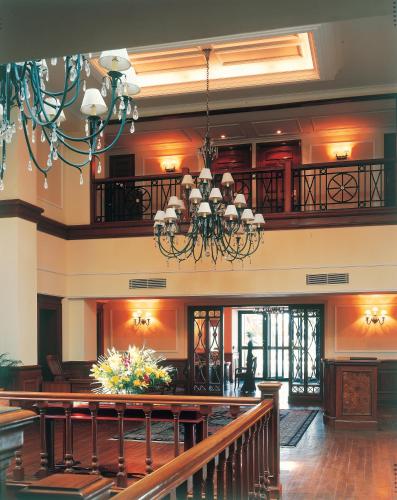 a large room with a table and a chandelier at The Oberoi Cecil in Shimla