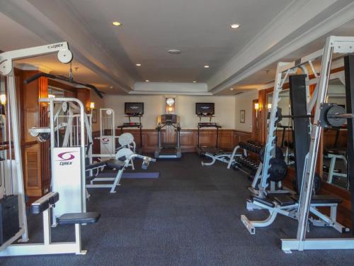 a gym with several treadmills and machines at The Oberoi Cecil in Shimla