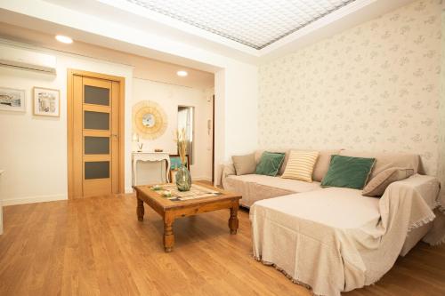 a living room with a couch and a coffee table at Apartamento La Luz by Clabao in Denia