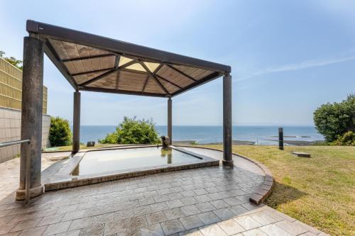 a pavilion with a view of the ocean at Spa and Resort Hotel Solage Oita Hiji Beppuwan in Beppu