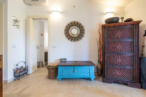 a room with a blue table and a mirror on the wall at Casa Cò in Costa Rei