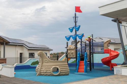 a playground with a slide and slides at BALLITO HILLS , 2 bedroom apartment in Ballito