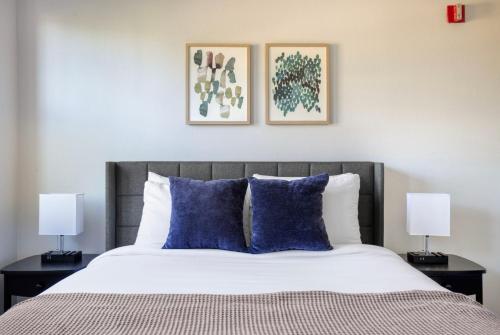 a bedroom with a bed with blue pillows and two lamps at Century City 2br w bbq roof lounge nr mall LAX-1118 in Los Angeles