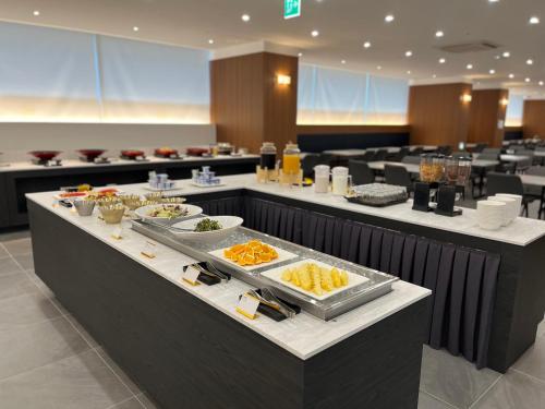 a buffet line with food on it in a restaurant at Haeundae Blue Story Hotel in Busan
