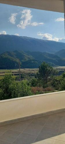 a view from a window of a field with a mountain at Hotel Eno in Përmet